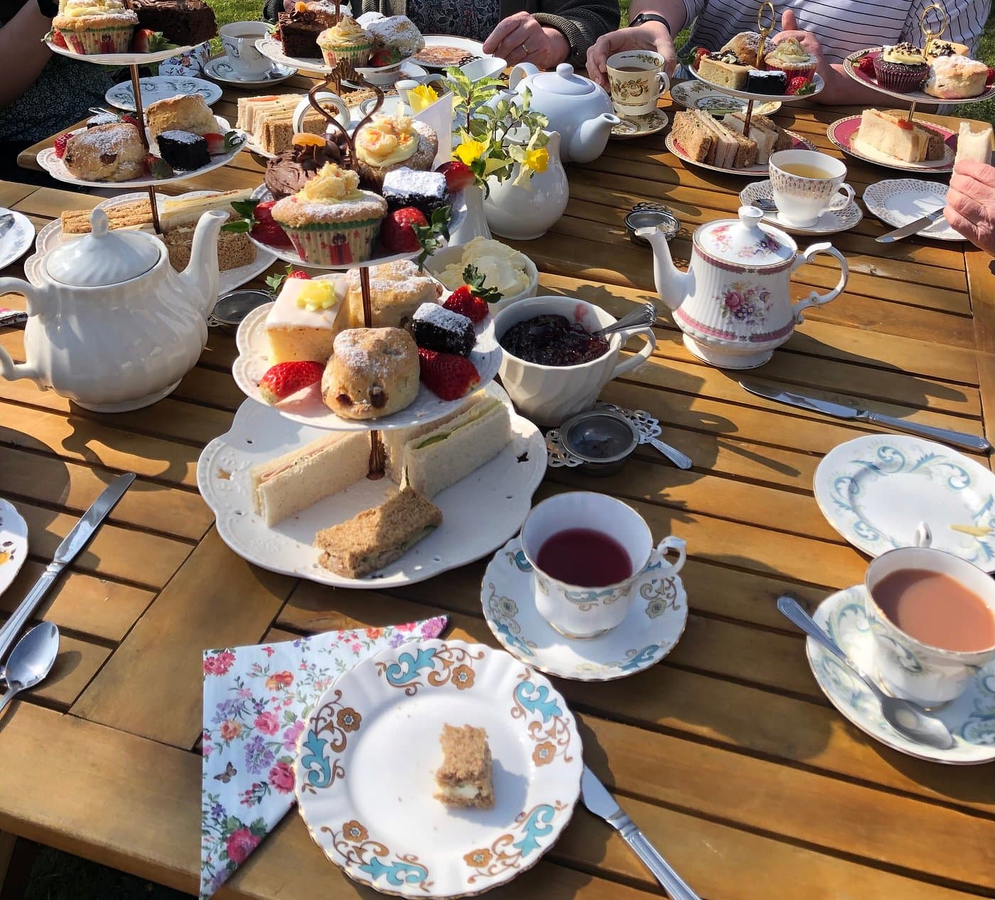 High tea table with cups and cakes